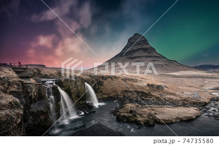 Northern lights aurora borealis over kirkjufell waterfall in Iceland 74735580