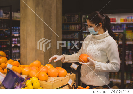 Grocery shopping in supermarket or store while pandemic 74736118