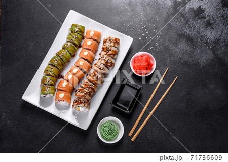 Fresh tasty sushi rolls laid out in the form of a dragon with ginger and wasabi 74736609