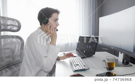 Attractive young woman working at call center Attractive young woman working at call center 74736968