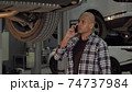 Young African man talking on the phone at car repair station 74737984