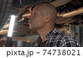 Cropped shot of a young male driver working at his garage 74738021