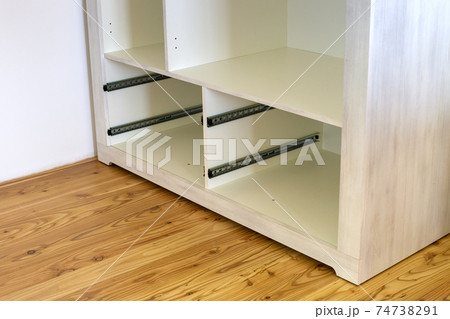 Close up of installation of wooden drawer in contemporary cupboard cabinet. 74738291