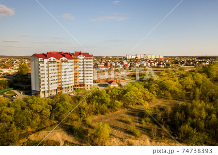 Aerial view of high residential apartment building in green rural area in Ivano-Frankivsk city, Ukraine Aerial view of high residential apartment building in green rural area in Ivano-Frankivsk city, Ukraine 74738393