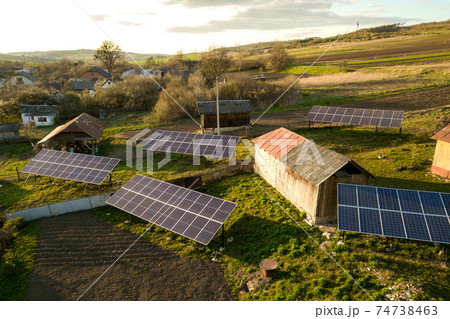 Aerial top down view of solar panels in green rural village yard. 74738463