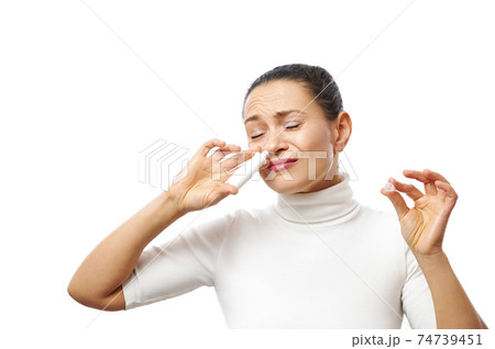 Young woman applying nasal spray posing at camera isolated on white background Young woman applying nasal spray posing at camera isolated on white background 74739451
