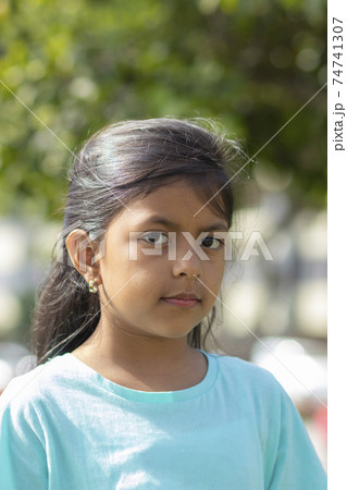 Cute little girl with long hair and black eyes 74741307