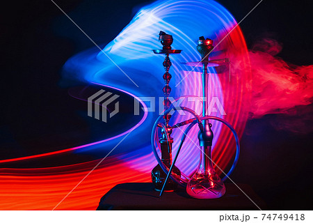 smoky Turkish hookahs with coals on bowls and water in flasks smoky Turkish hookahs with coals on bowls and water in flasks 74749418