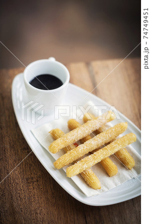 churros and chocolate spanish donuts with sauce breakfast snack 74749451