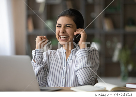 Overjoyed Indian woman get great news on cellphone 74753812