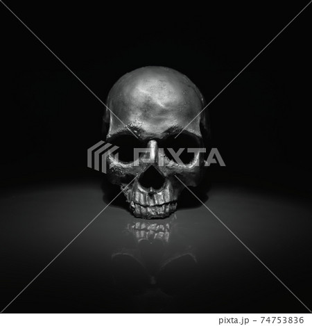 Spooky dark black skull aginast dark background Spooky dark black skull aginast dark background 74753836