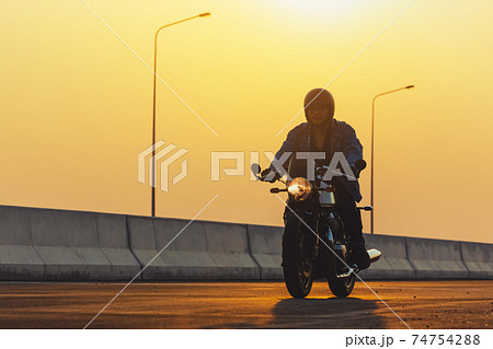 Young man riding big bike motocycle on asphalt high way against, Motorbike man has freedom 74754288