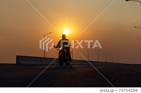 Young man riding big bike motocycle on asphalt high way against, Motorbike man has freedom 74754289