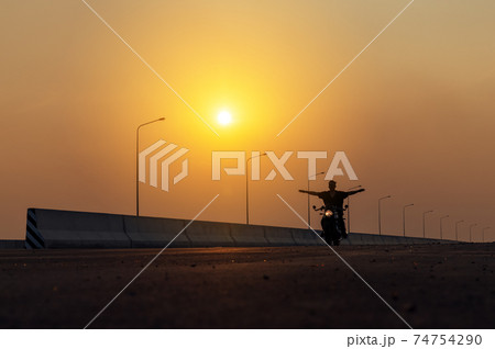 Young man riding big bike motocycle on asphalt high way against, Motorbike man has freedom 74754290