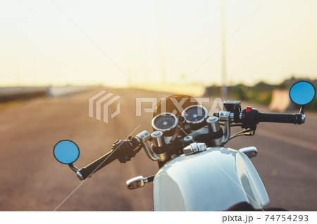 Hands of motorcyclist on a street Alpine highway 74754293