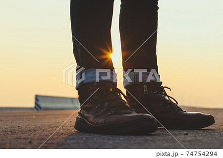 Low Section Of Man Standing On Road 74754294