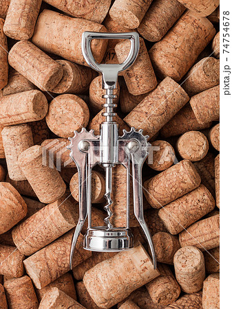 Steel modern corkscrew on top of various wine corks Steel modern corkscrew on top of various wine corks 74754678