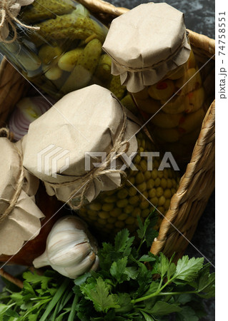 Basket with pickled food and ingredients on black smokey background Basket with pickled food and ingredients on black smokey background 74758551