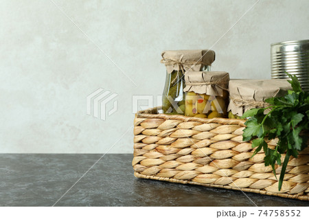 Basket with pickled food and ingredients on black smokey table Basket with pickled food and ingredients on black smokey table 74758552