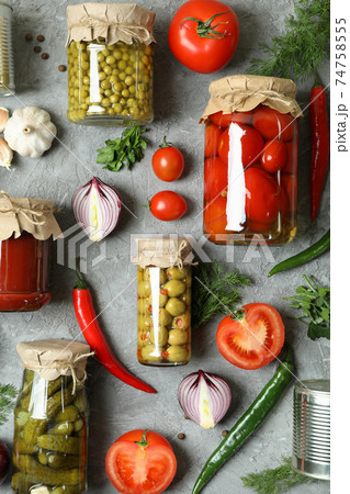 Flat lay with different canned food and ingredients on gray background Flat lay with different canned food and ingredients on gray background 74758555