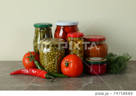 Jars with different pickled food on gray table Jars with different pickled food on gray table 74758689