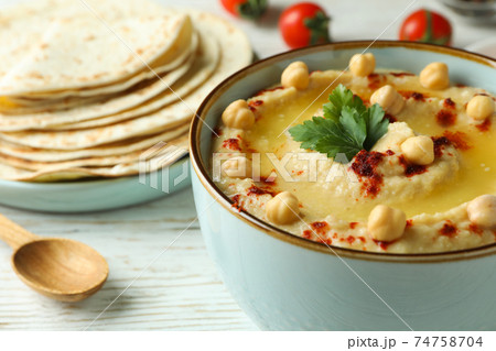 Concept of cooking hummus on white wooden background 74758704