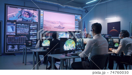 Team watching rocket launch in office Team watching rocket launch in office 74760030