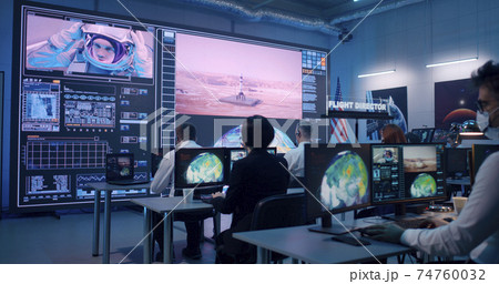 Team watching rocket launch in office 74760032