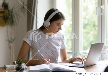 Millennial female student study online on laptop 74760188