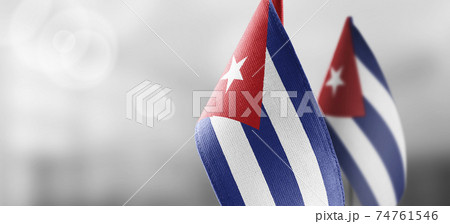 Small national flags of the Cuba on a light blurry background Small national flags of the Cuba on a light blurry background 74761546