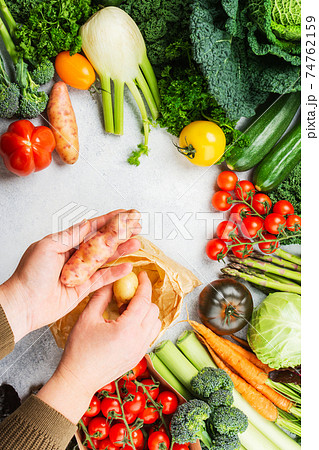 Variety of organic vegetables on blue table Variety of organic vegetables on blue table 74762159