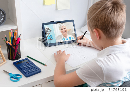 Remote learning concept with boy using tablet Remote learning concept with boy using tablet 74763191