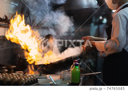 Chef stirring cooking 74765085