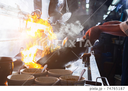 Chef stir fry cooking 74765187