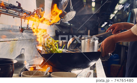 Chef stir fry cooking 74765480