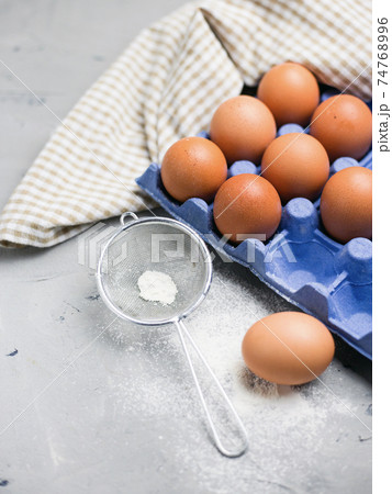 Ingredients for pastries: flour, eggs on light gray background Ingredients for pastries: flour, eggs on light gray background 74768996