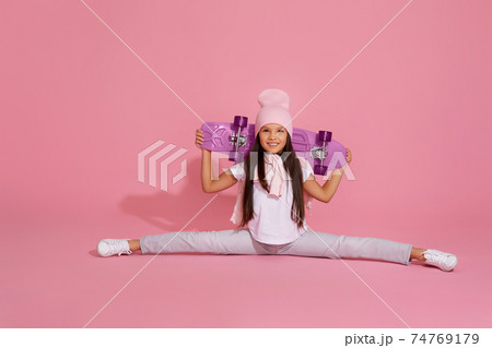 girl sitting on a transverse twine and holding skateboard girl sitting on a transverse twine and holding skateboard 74769179