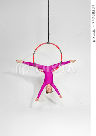 Girl gymnast shows an acrobatic performance 74769237