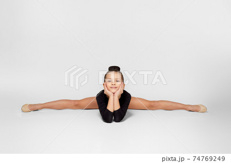 girl in black sportswear sitting on a transverse twine. 74769249