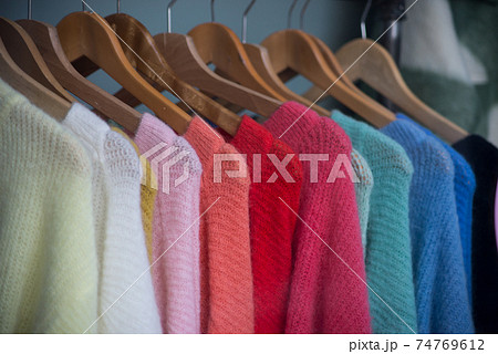 Closeup of colorful woolen pullover on hangers in a fashion tore showroom 74769612
