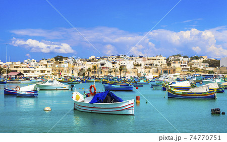 Marsaxlokk village with traditional colorful fishing boats Luzzu in Malta Marsaxlokk village with traditional colorful fishing boats Luzzu in Malta 74770751