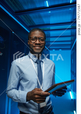 Smiling African American Man in Server Room Smiling African American Man in Server Room 74771587
