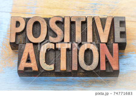 positive action - word abstract in wood type 74771683