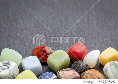 colorful gemstones on slate stone 74773525