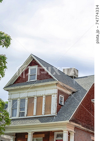 Exterior view of home with dormers and front porch framed by square columns Exterior view of home with dormers and front porch framed by square columns 74774334