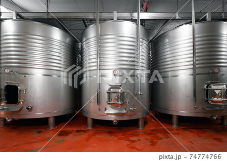 Industrial stainless steel vats in modern brewery. 74774766