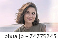 Portrait of smiling charming young woman with happy face. 74775245