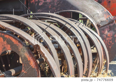 Damaged and rusty wheels of an old vintage tractor on a farm on a sunny day 74776609