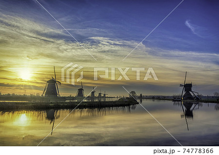 Rotterdam Netherlands, sunrise nature landscape of Dutch Windmill at Kinderdijk Village 74778366