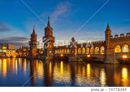 Berlin Germany, night city skyline at Oberbaum Bridge and Berlin Metro 74778384